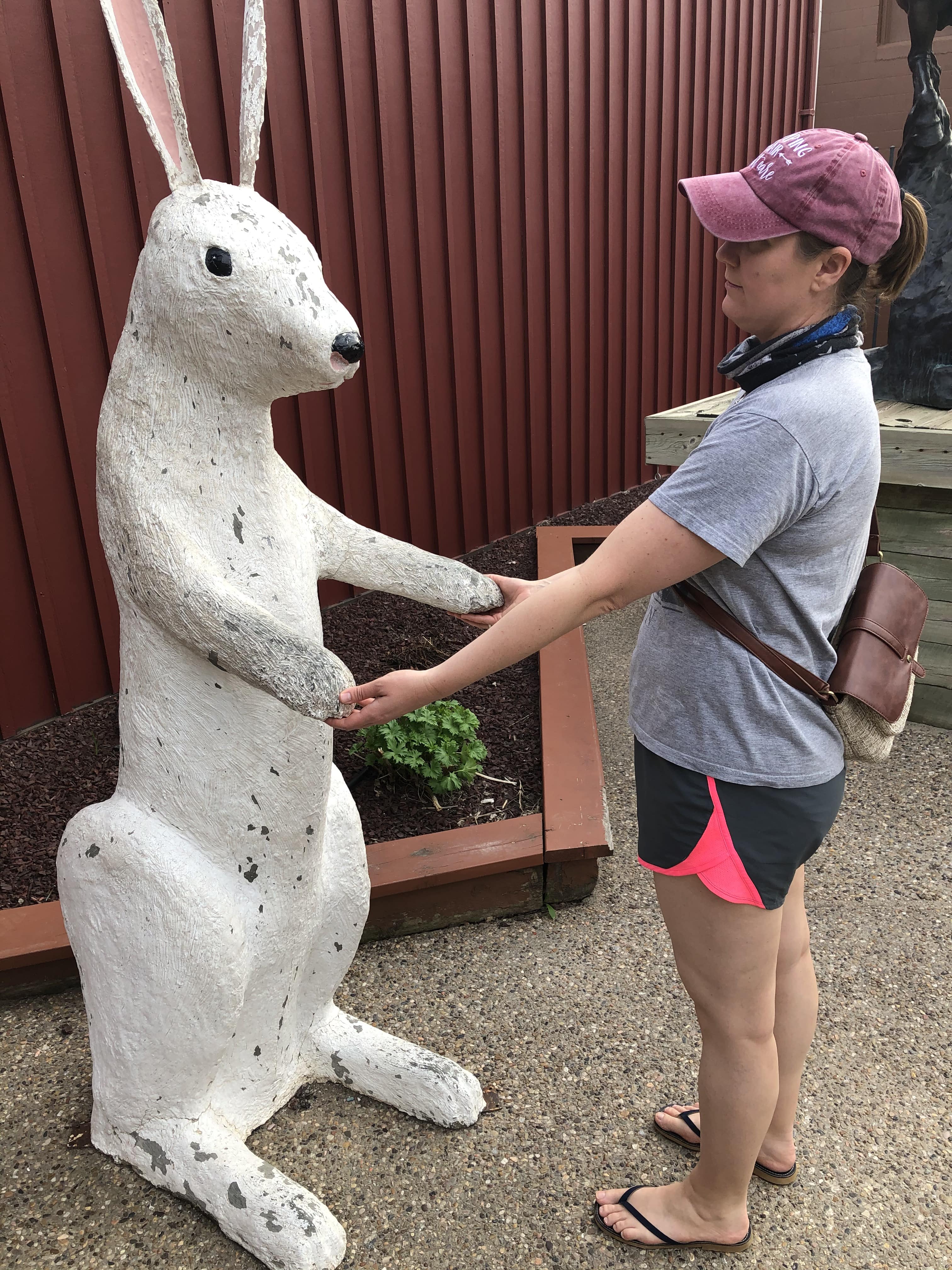 Shelly making friends with a six foot tall rabbit statue